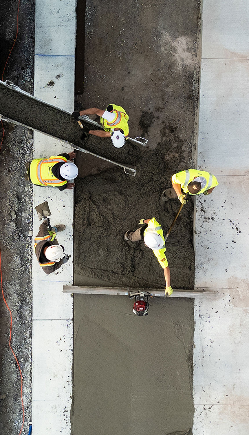 Aerial view of workers pouring concrete