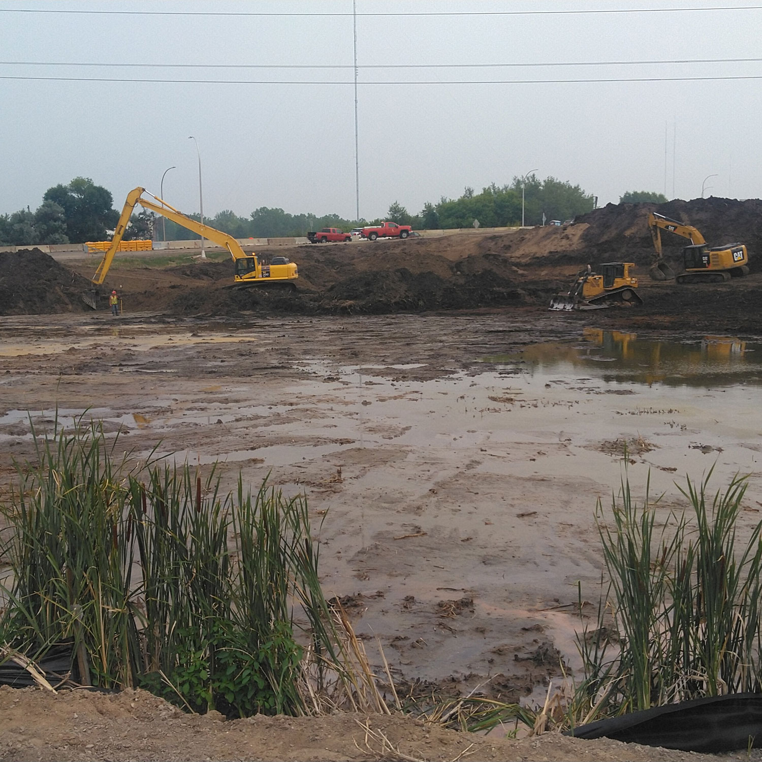 Excavators and person wearing PPE 