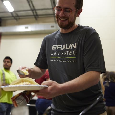 Braun Intertec employee putting food on a plate