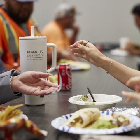 Food on a table with people around it