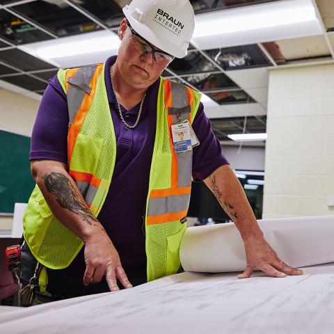 A person looking at construction plans