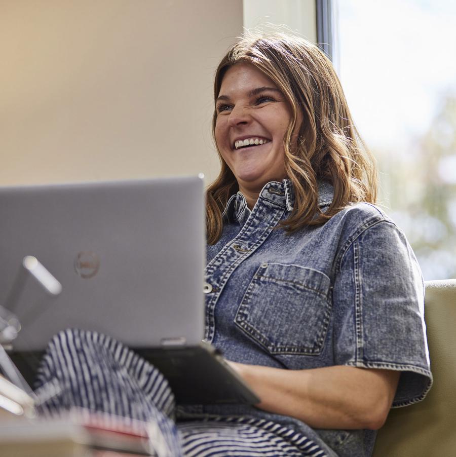 Women working on a computer laughing