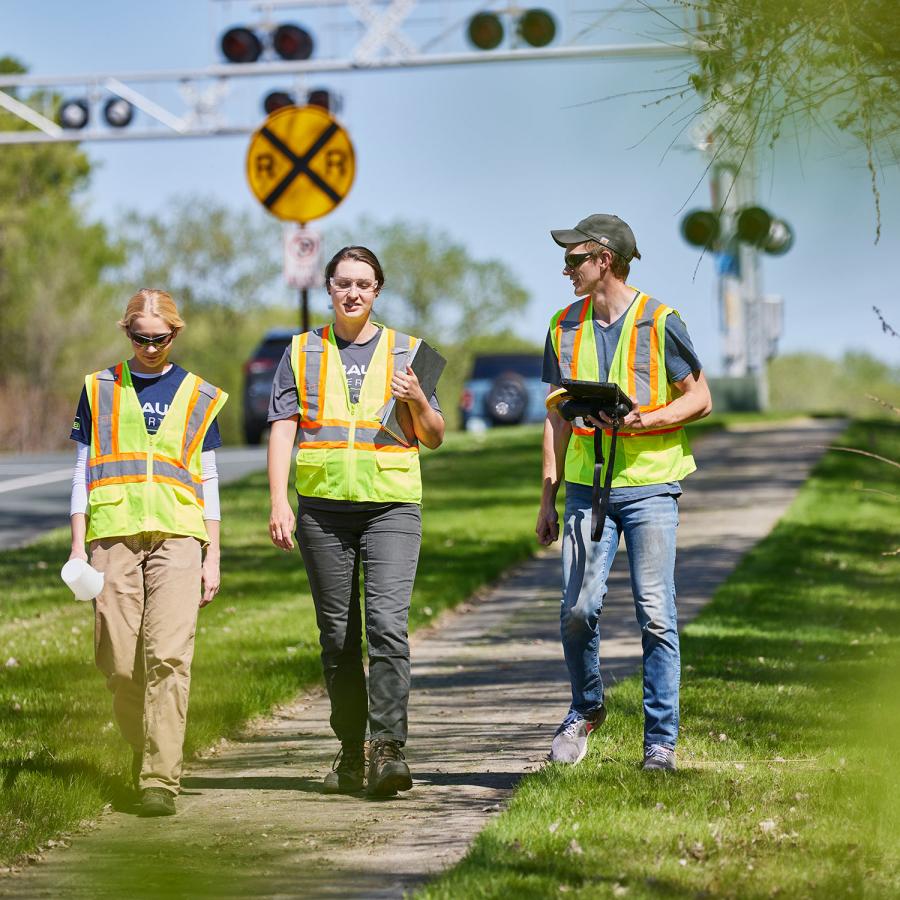 Three people in PPE walking together 
